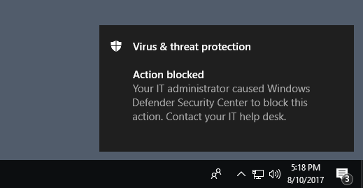 Example notification that says Action blocked: Your IT administrator caused Windows Defender Antivirus to block this action. Contact your IT desk.